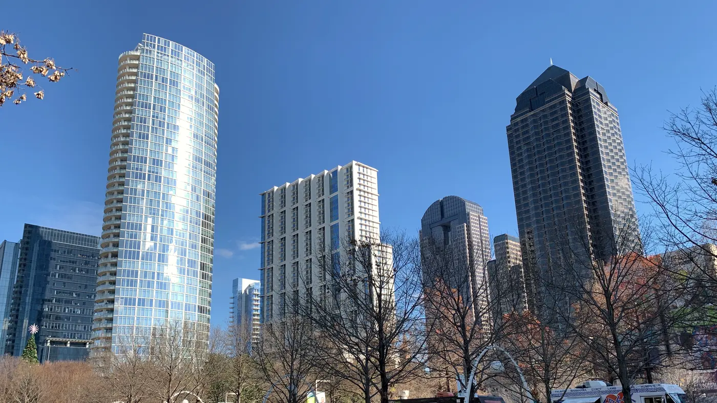Uptown Dallas glass towers above a park on a sunny day