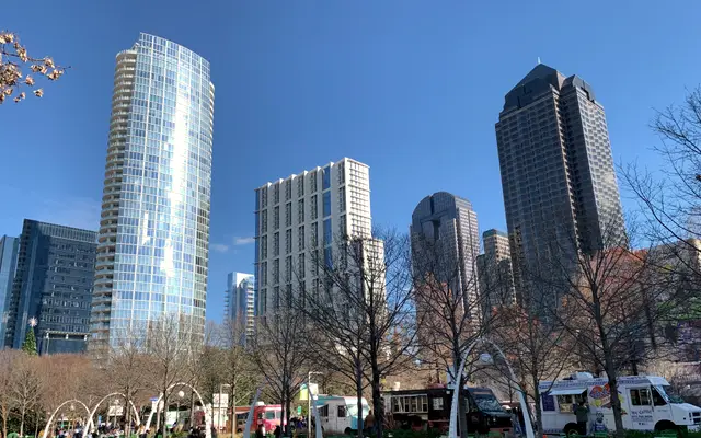 Uptown Dallas glass towers above a park on a sunny day