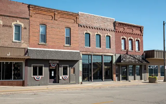 Row of brick storefronts on a small-town main street