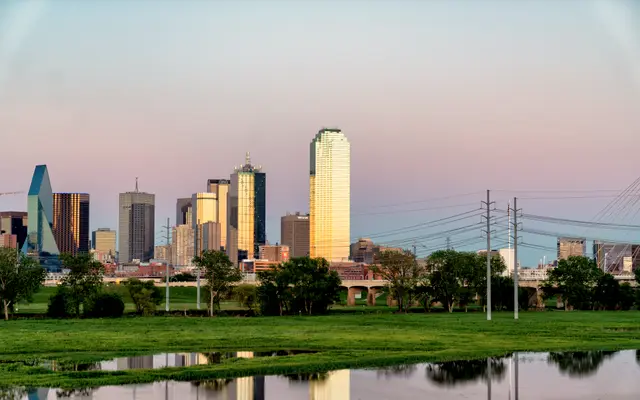 Dallas skyline at dusk reflected in Trinity River wetlands