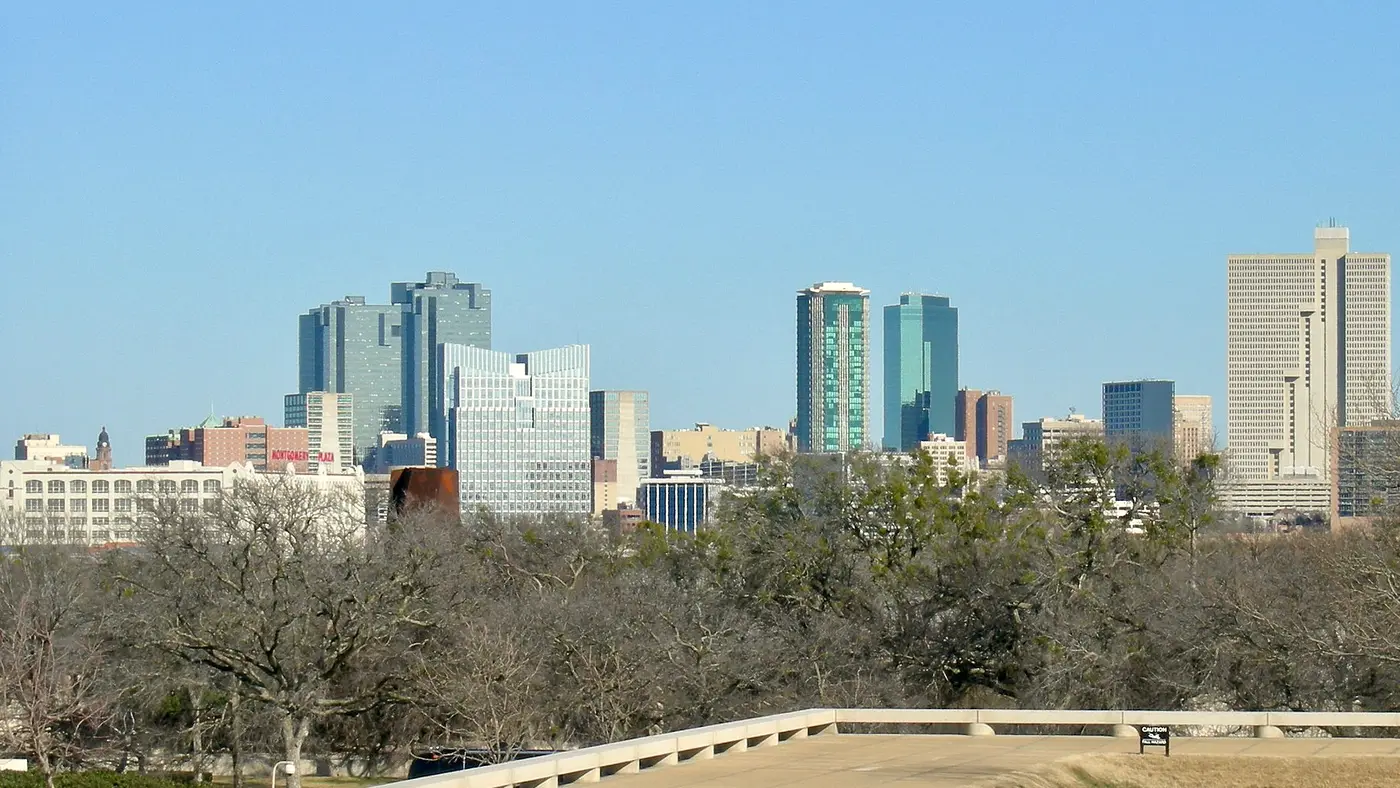 Fort Worth skyline above trees on a clear day