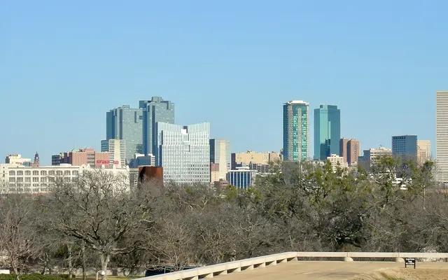 Fort Worth skyline above trees on a clear day