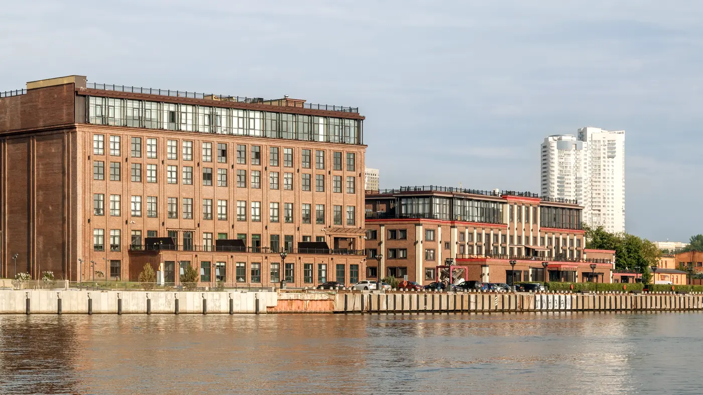 Brick loft office buildings along a calm waterfront