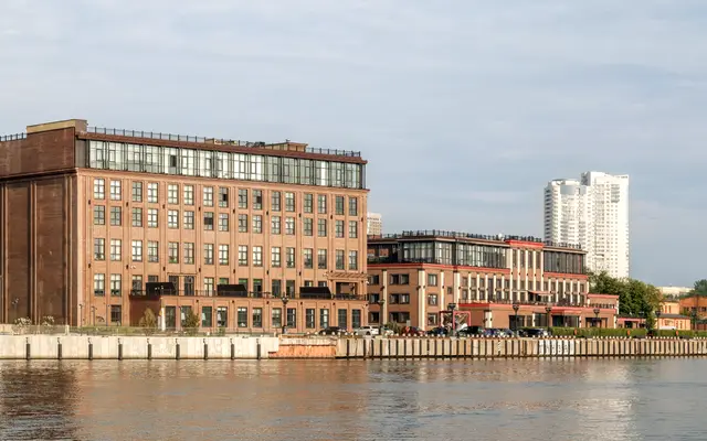 Brick loft office buildings along a calm waterfront