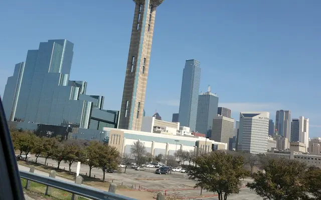 Reunion Tower beside glass hotel towers in downtown Dallas