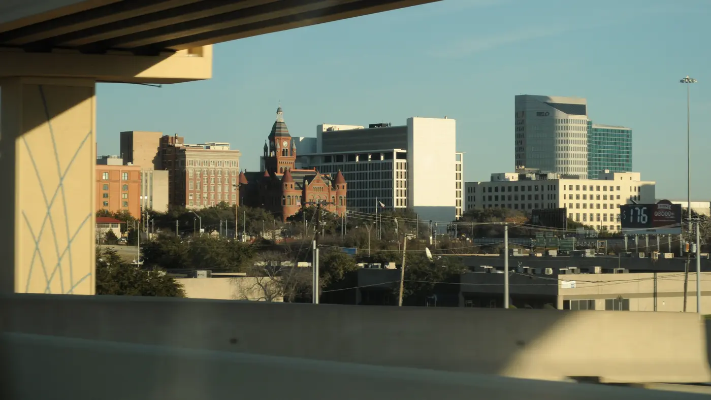 Old Red Courthouse and Dallas towers framed beneath an overpass