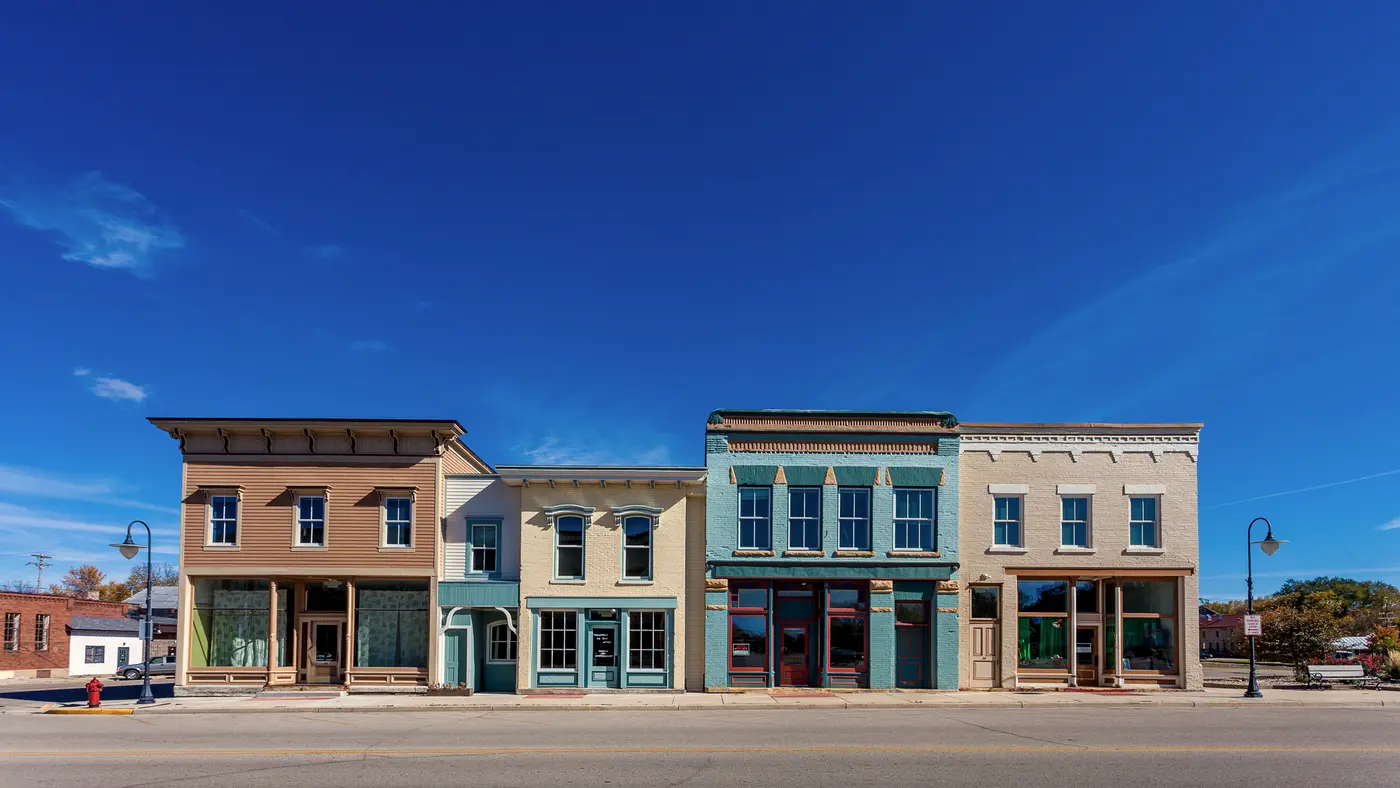 Row of restored historic storefronts on a quiet small-town main street