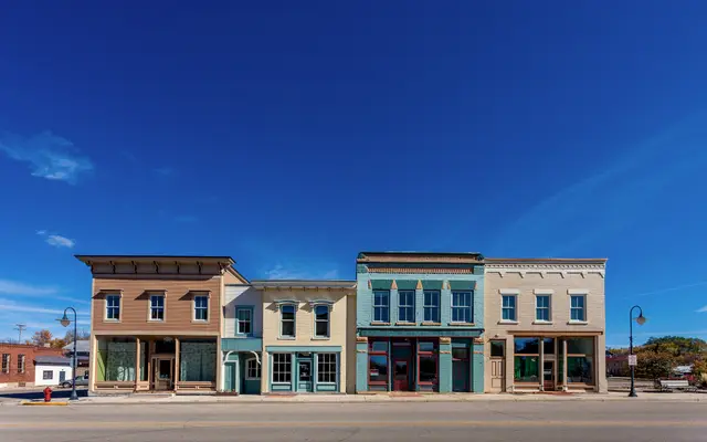 Row of restored historic storefronts on a quiet small-town main street