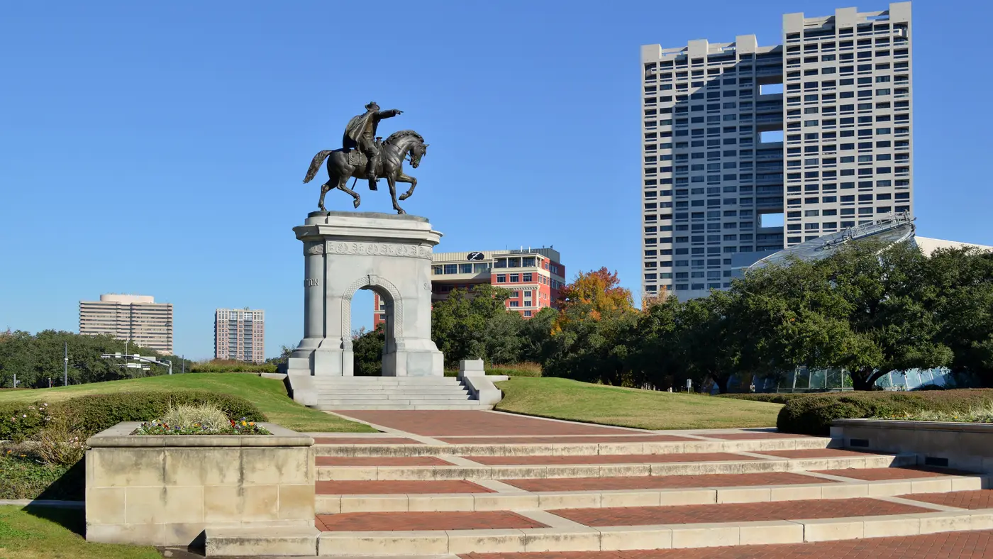 Sam Houston equestrian monument in Hermann Park with towers behind