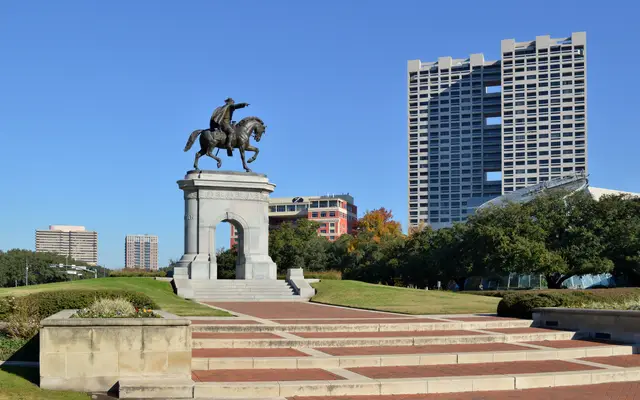 Sam Houston equestrian monument in Hermann Park with towers behind