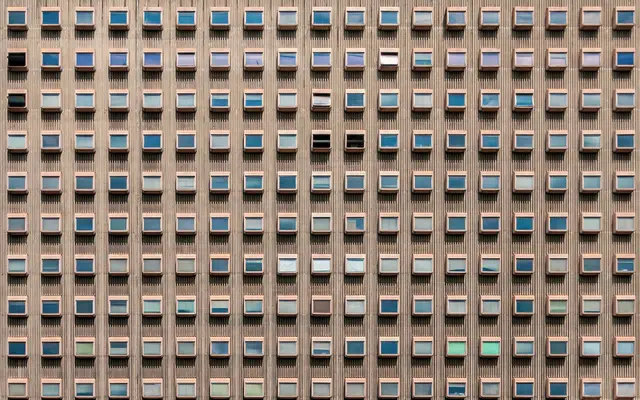 Office tower facade with a regular grid of small windows