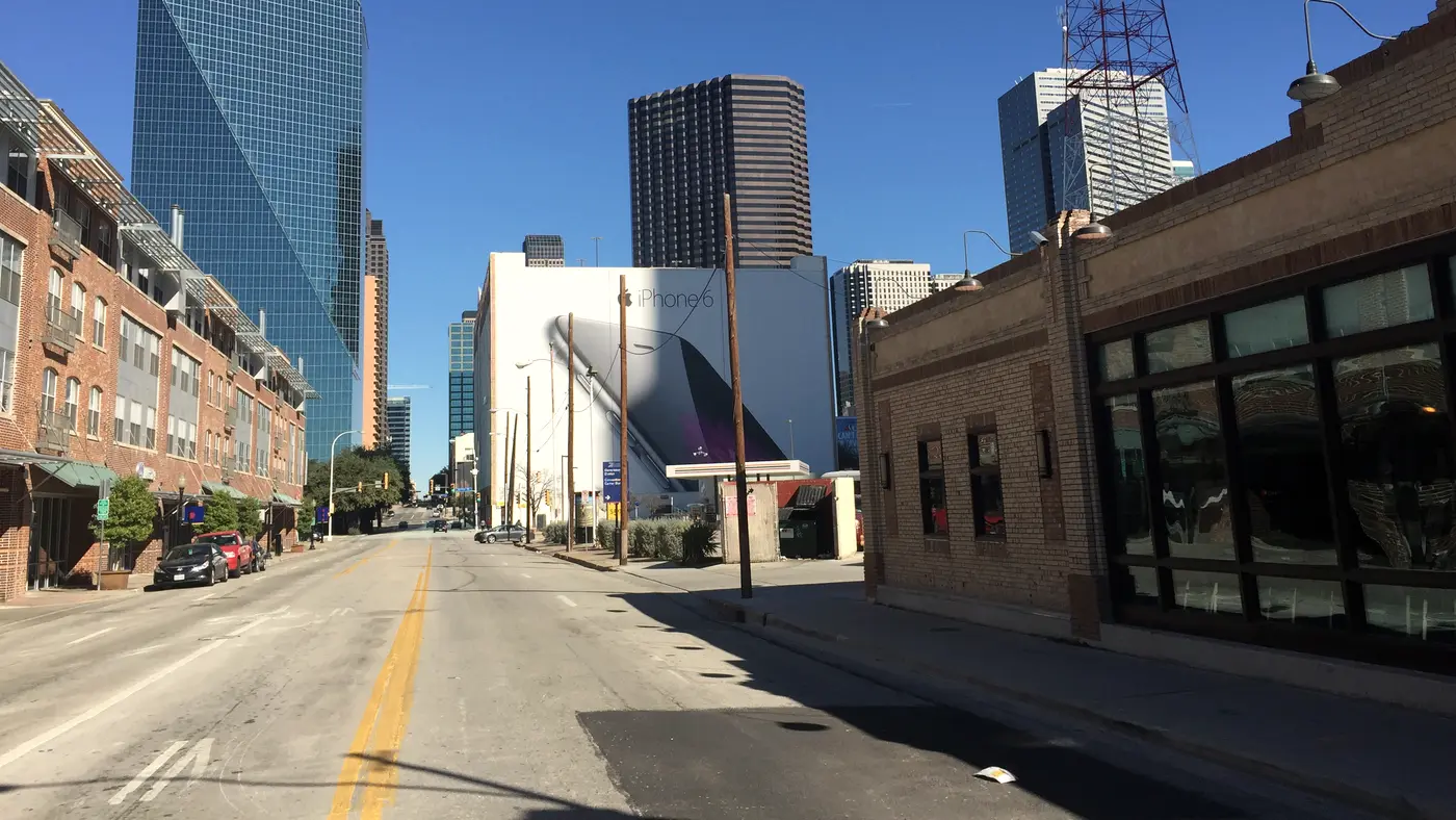 Downtown Dallas street leading to the Fountain Place glass tower