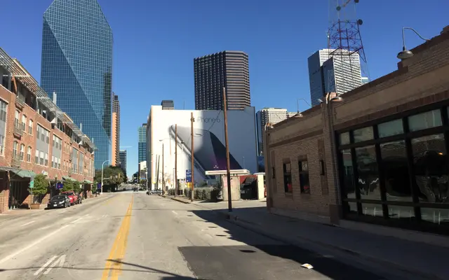 Downtown Dallas street leading to the Fountain Place glass tower