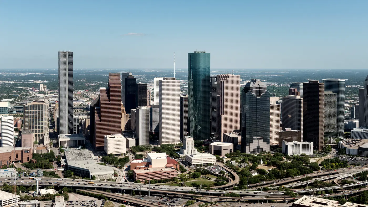 Aerial view of downtown Houston towers and curving freeway interchanges