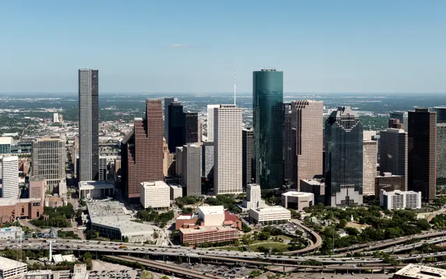 Aerial view of downtown Houston towers and curving freeway interchanges