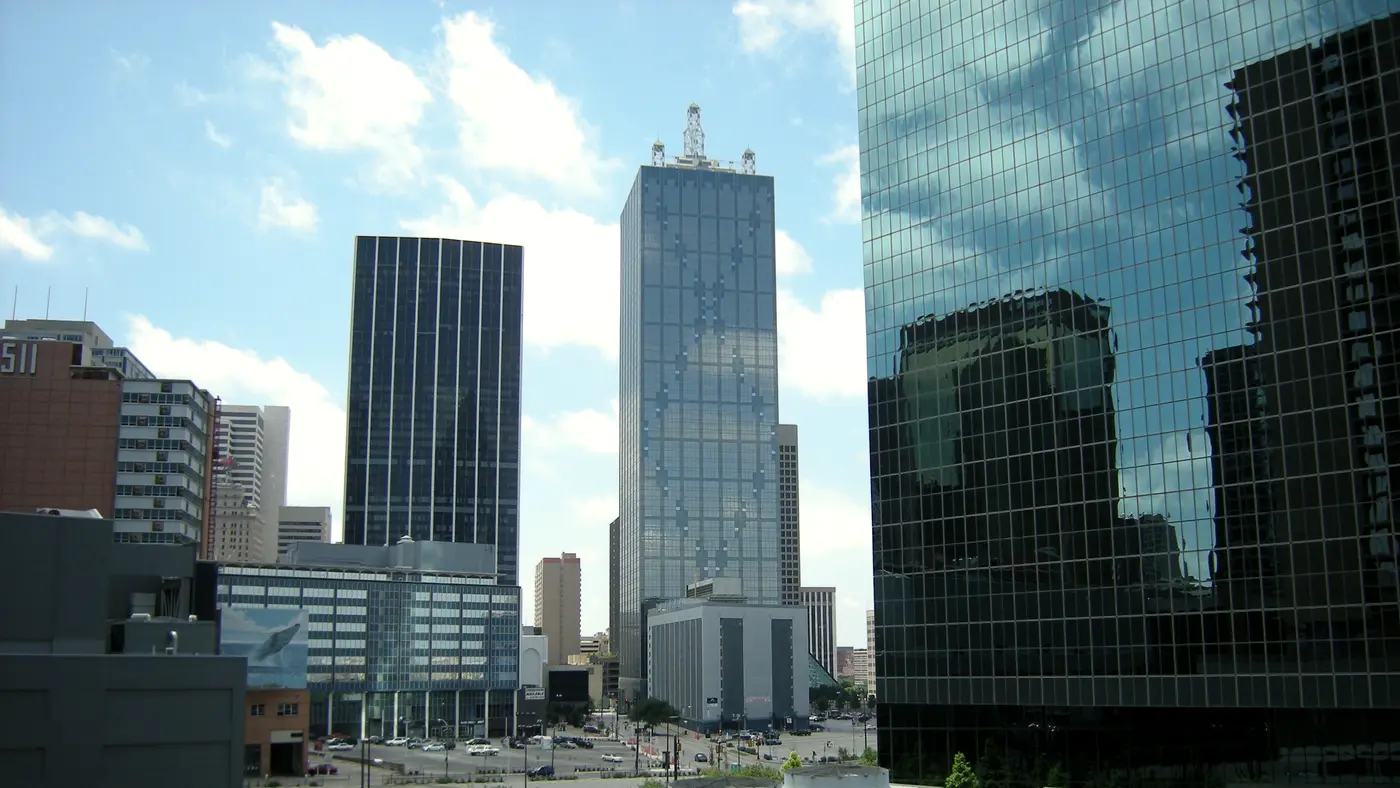 Downtown Dallas glass office towers under a blue sky