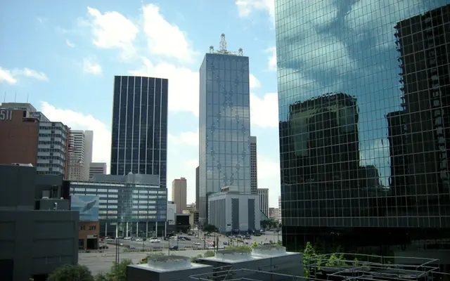 Downtown Dallas glass office towers under a blue sky