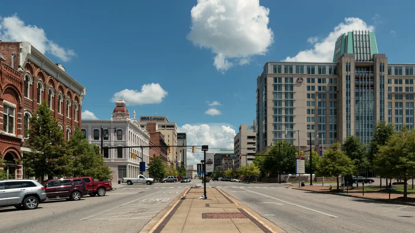 Wide empty downtown street lined with historic and modern buildings