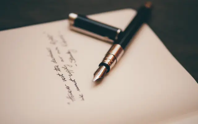 Fountain pen resting on a handwritten note