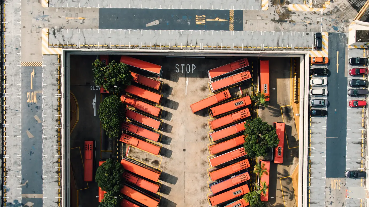 Aerial view of truck trailers parked in a walled depot yard