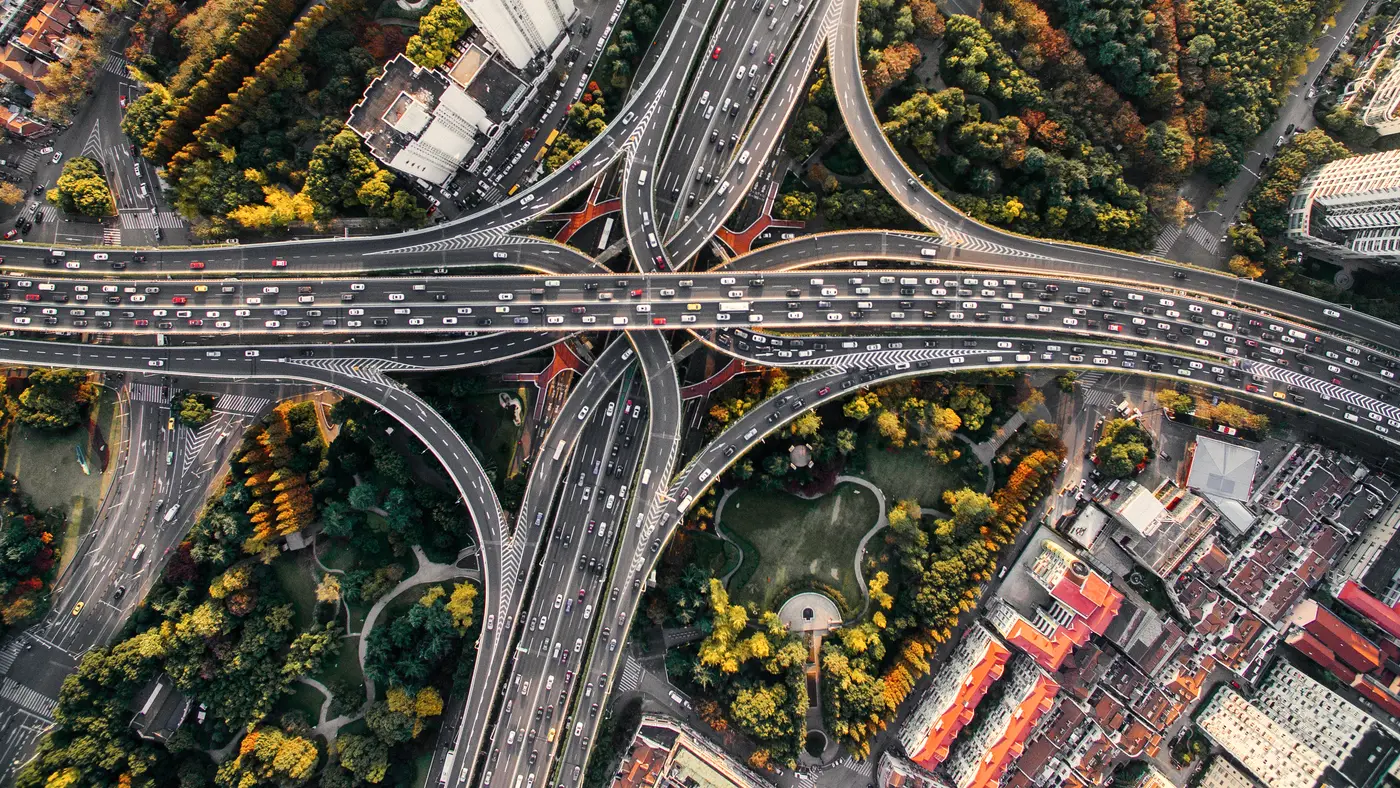 Aerial view of a highway interchange winding through a city