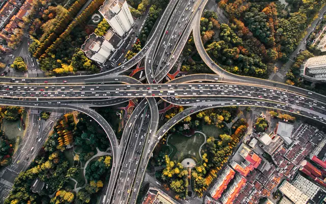 Aerial view of a highway interchange winding through a city