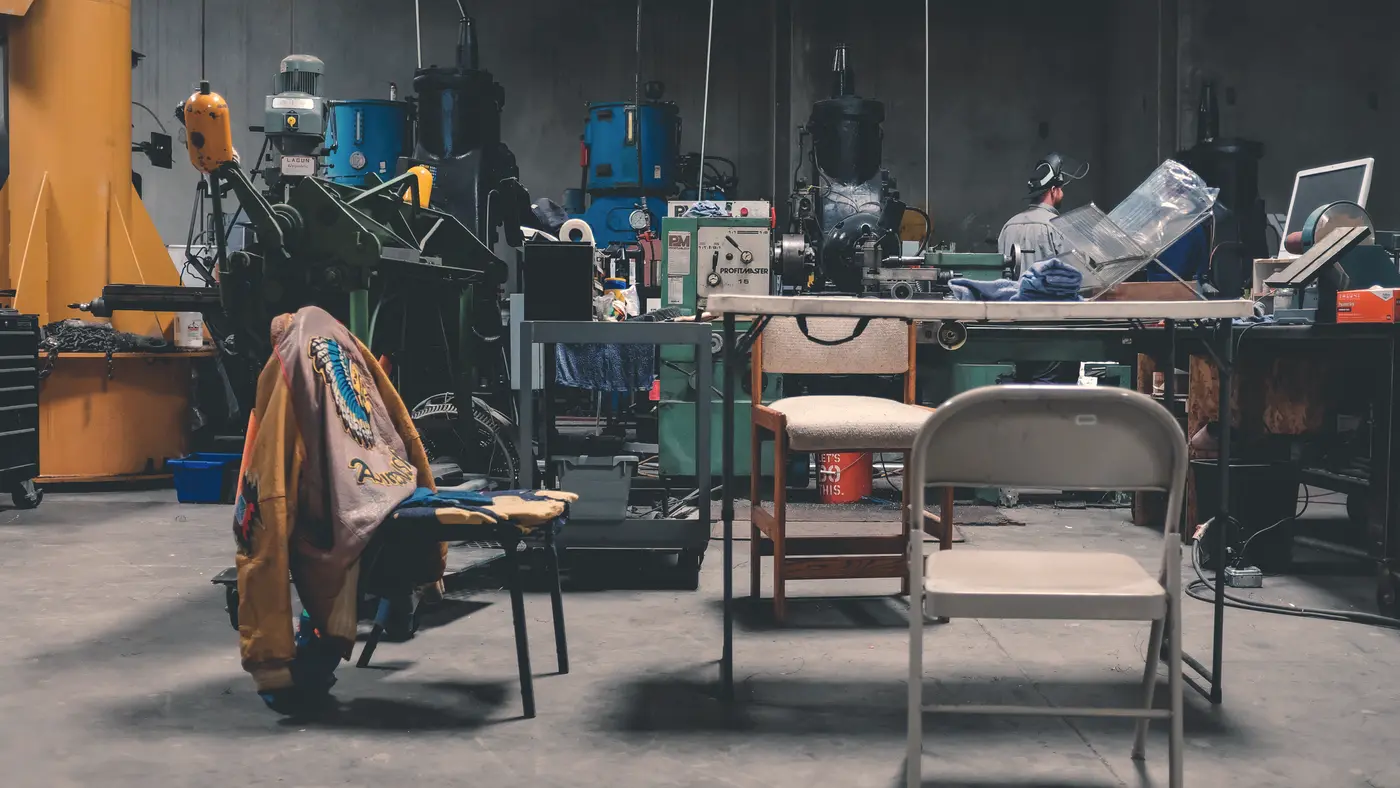 Machine shop floor with milling machines and workbenches