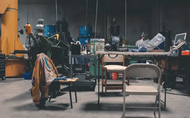 Machine shop floor with milling machines and workbenches