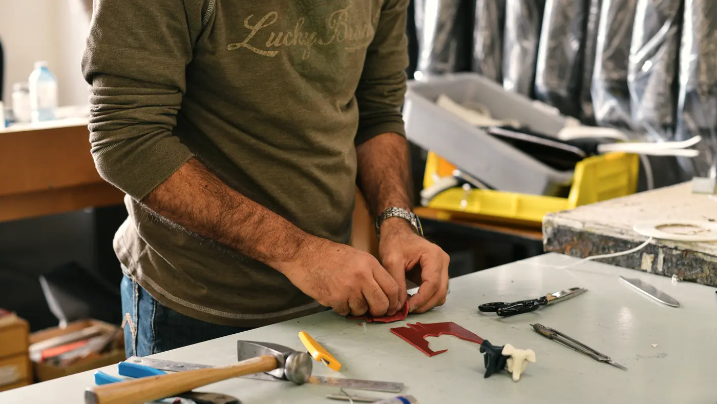 Craftsman laying out hand tools on a workbench