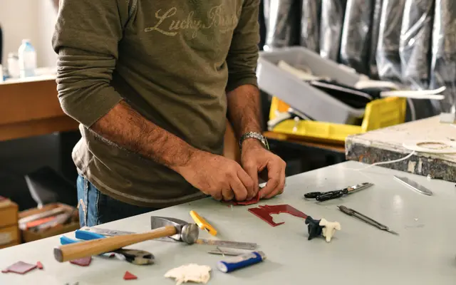 Craftsman laying out hand tools on a workbench