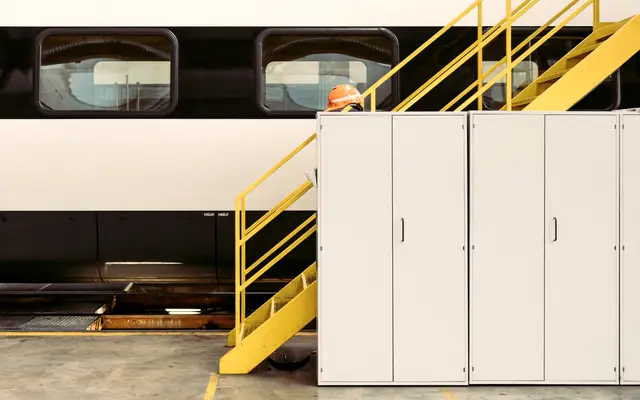 Clean industrial plant floor with yellow steel stairs and cabinets