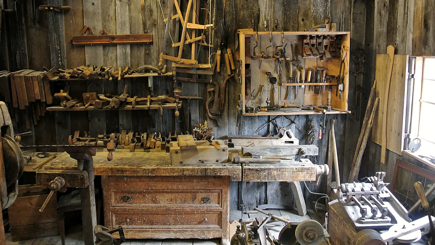 Traditional woodworking shop with hand tools hanging on the walls