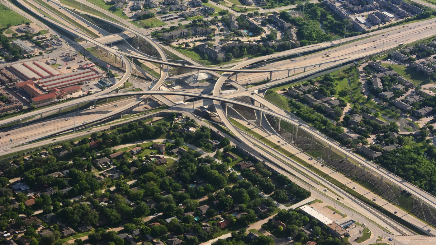 Aerial view of a highway interchange above suburban neighbourhoods