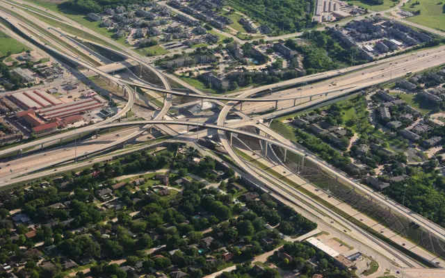 Aerial view of a highway interchange above suburban neighbourhoods