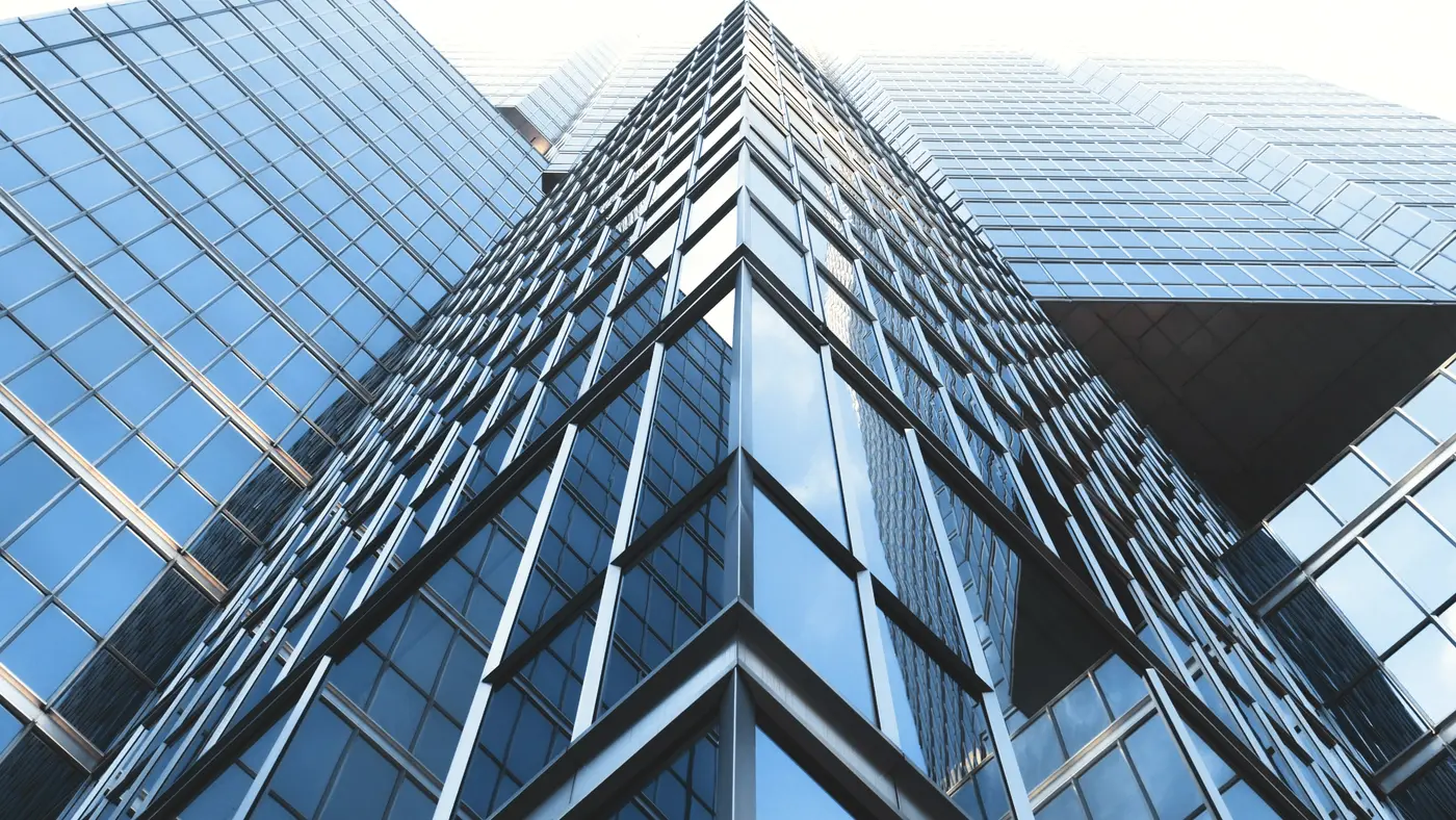 Blue glass office tower seen from street level