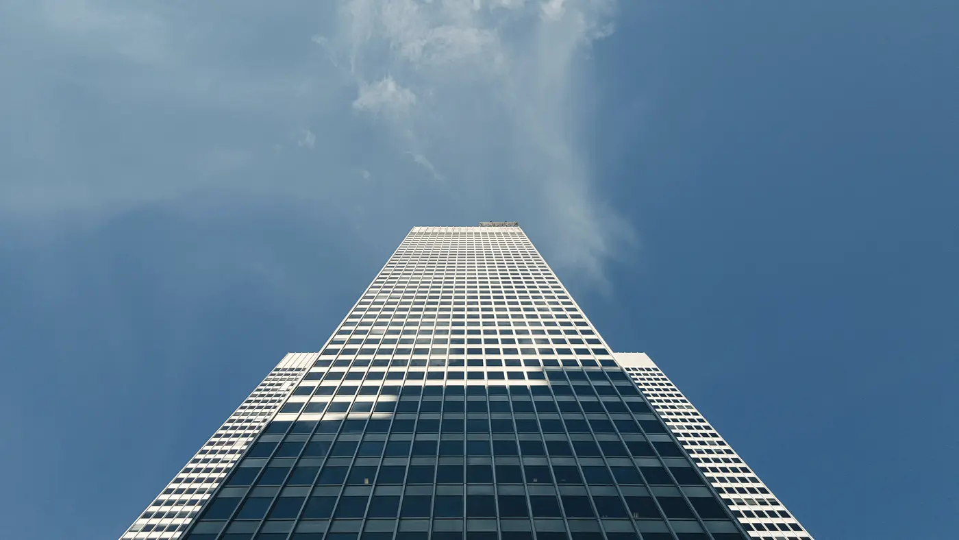 Office skyscraper seen from below under a blue sky