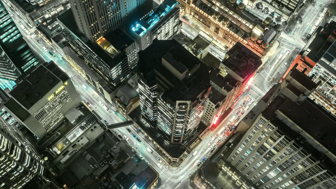 Aerial view of a lit downtown intersection at night