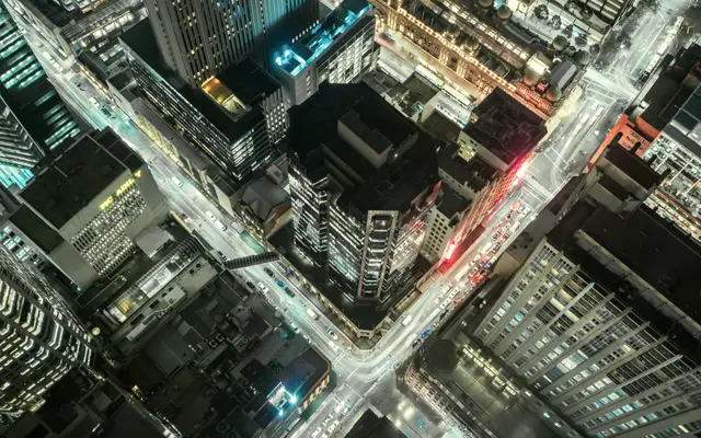 Aerial view of a lit downtown intersection at night