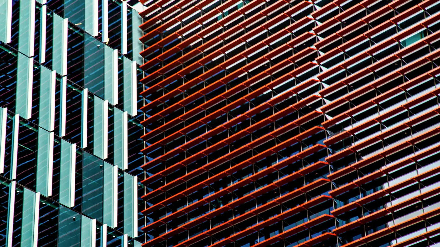 Modern facade of teal and rust colored vertical fins