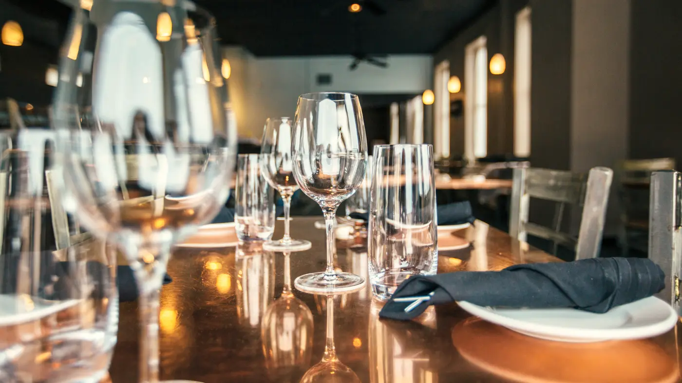 Set restaurant table with wine glasses in a quiet dining room