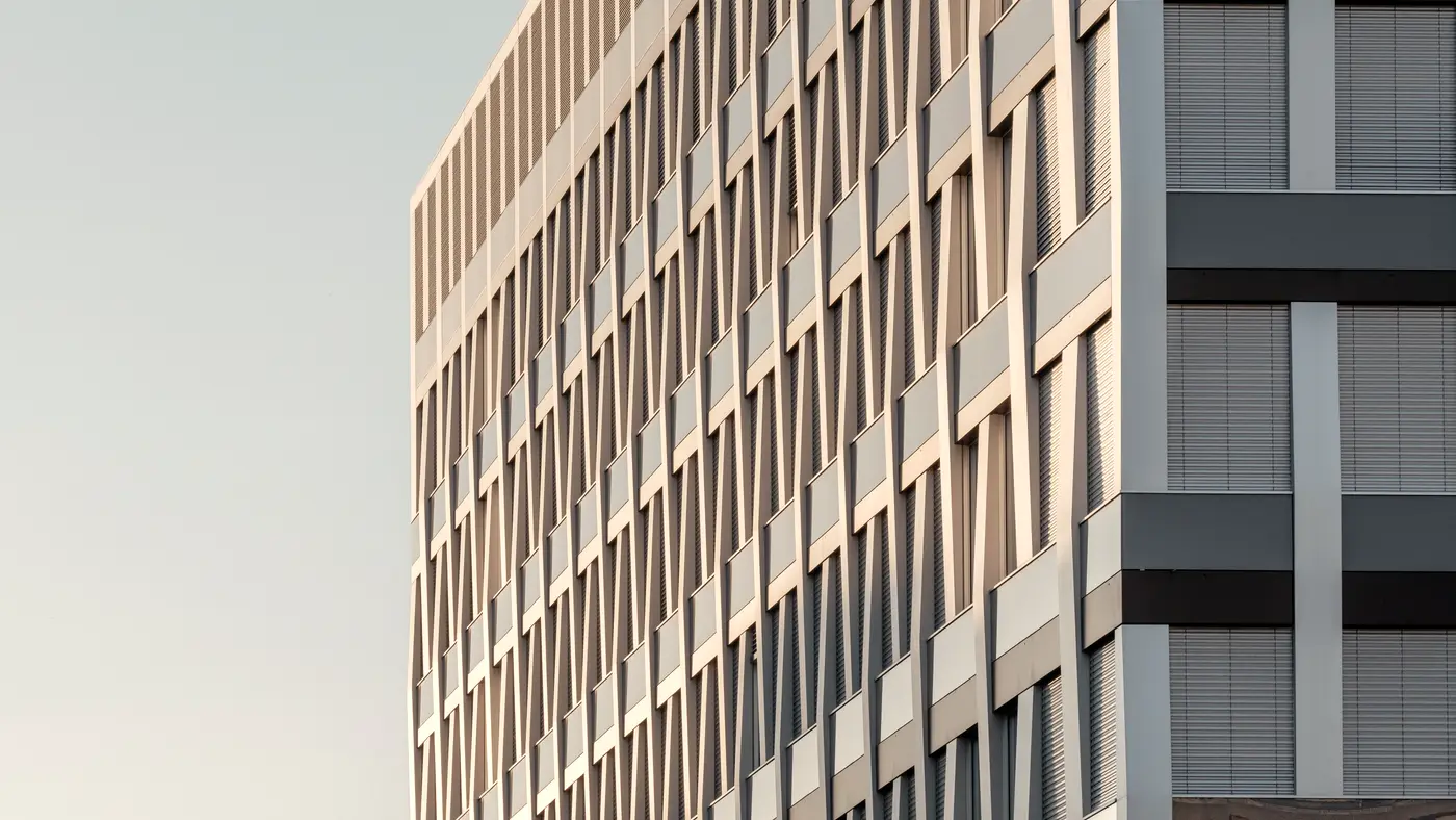 Clean modern office building facade under a pale sky