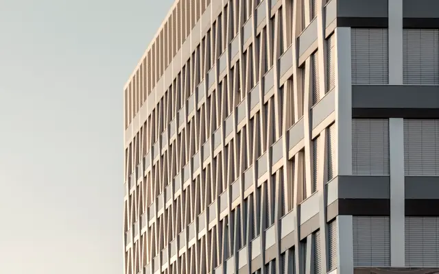 Clean modern office building facade under a pale sky