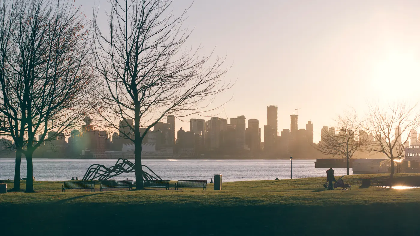 City skyline across the water seen from a park at sunset