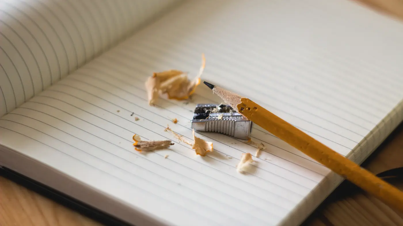 Lined notebook with a sharpened pencil and shavings