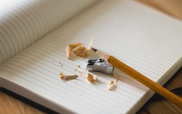 Lined notebook with a sharpened pencil and shavings