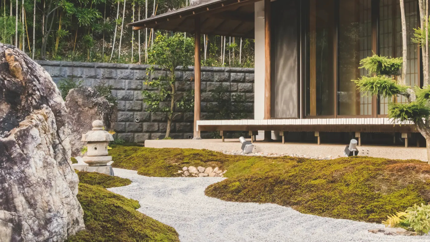 Landscaped garden with raked gravel, stones and a timber pavilion