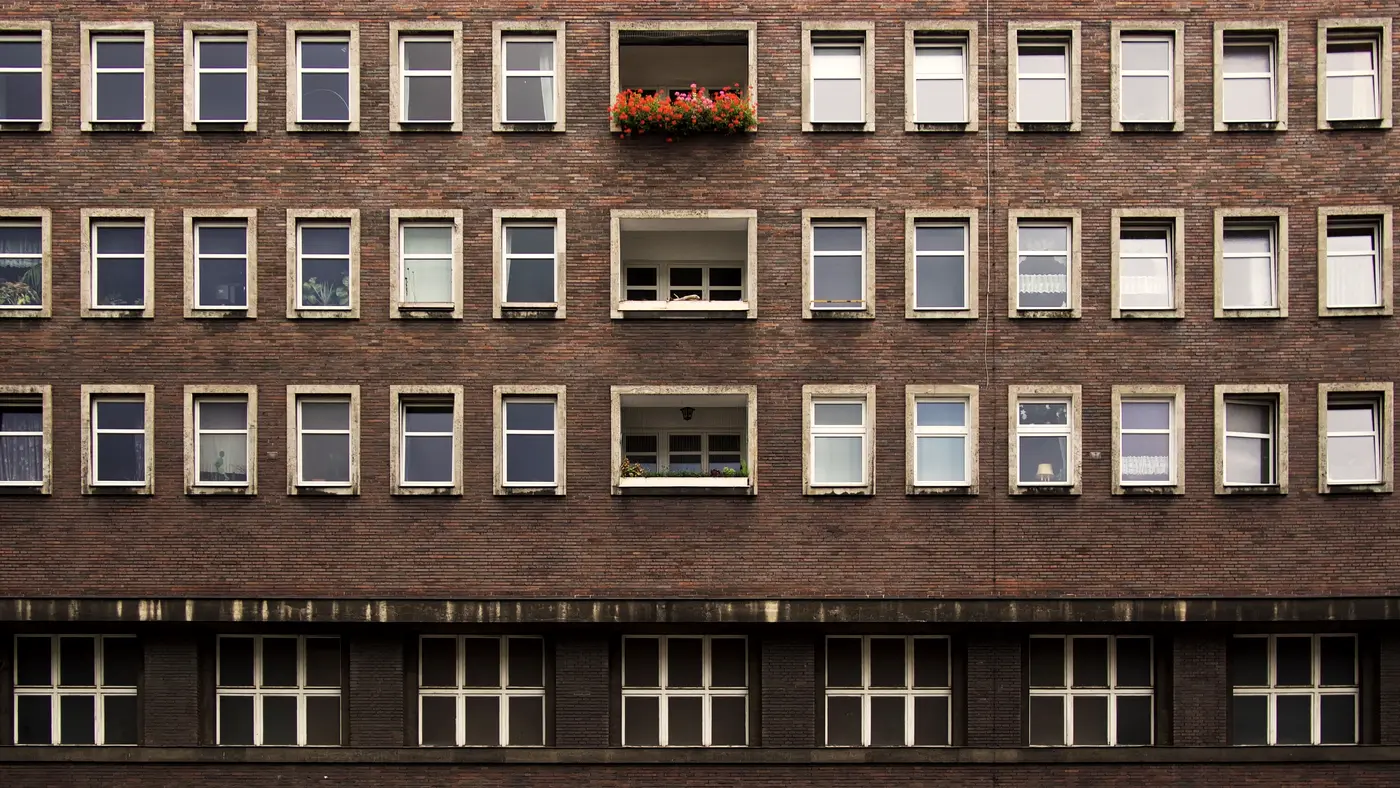 Brick office building facade with rows of identical windows