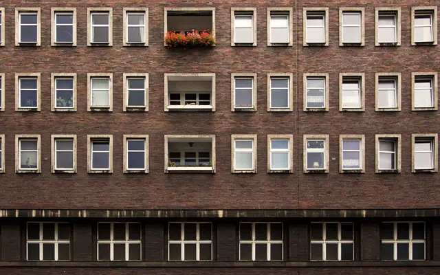 Brick office building facade with rows of identical windows