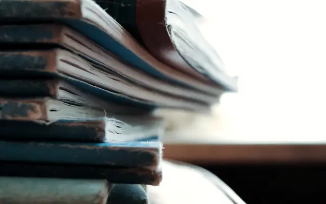 Close-up of a stack of worn old notebooks