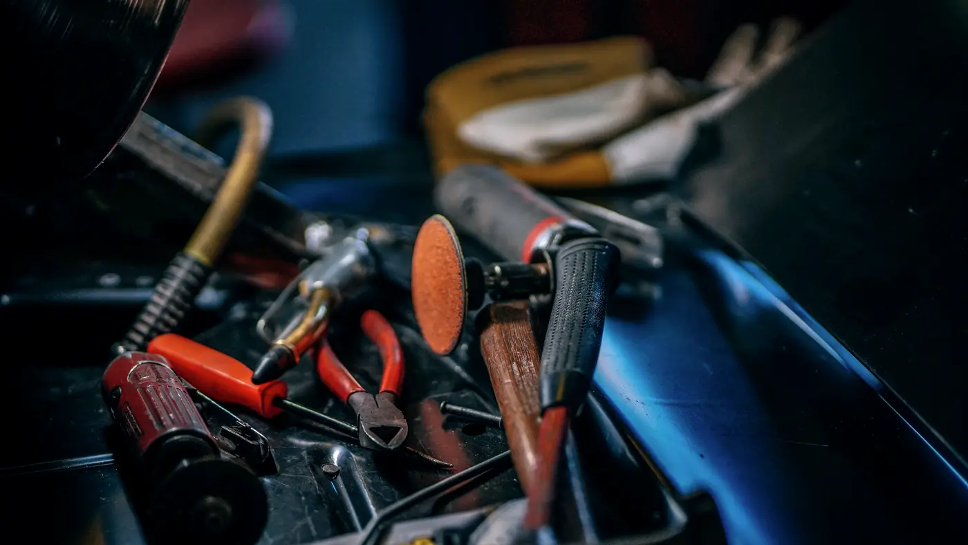 Toolbox full of pliers, cutters and worn hand tools